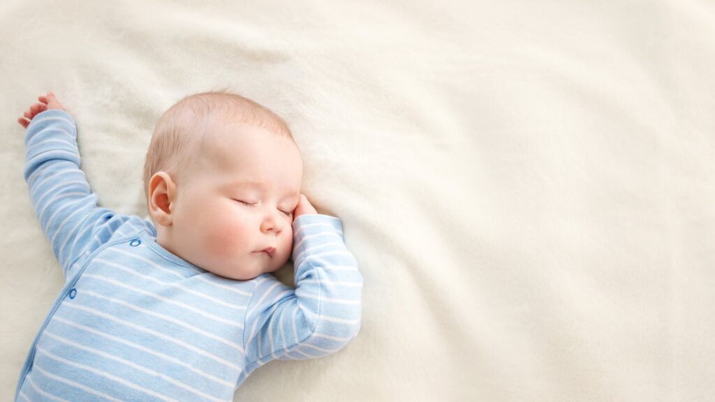 baby laying on blanket