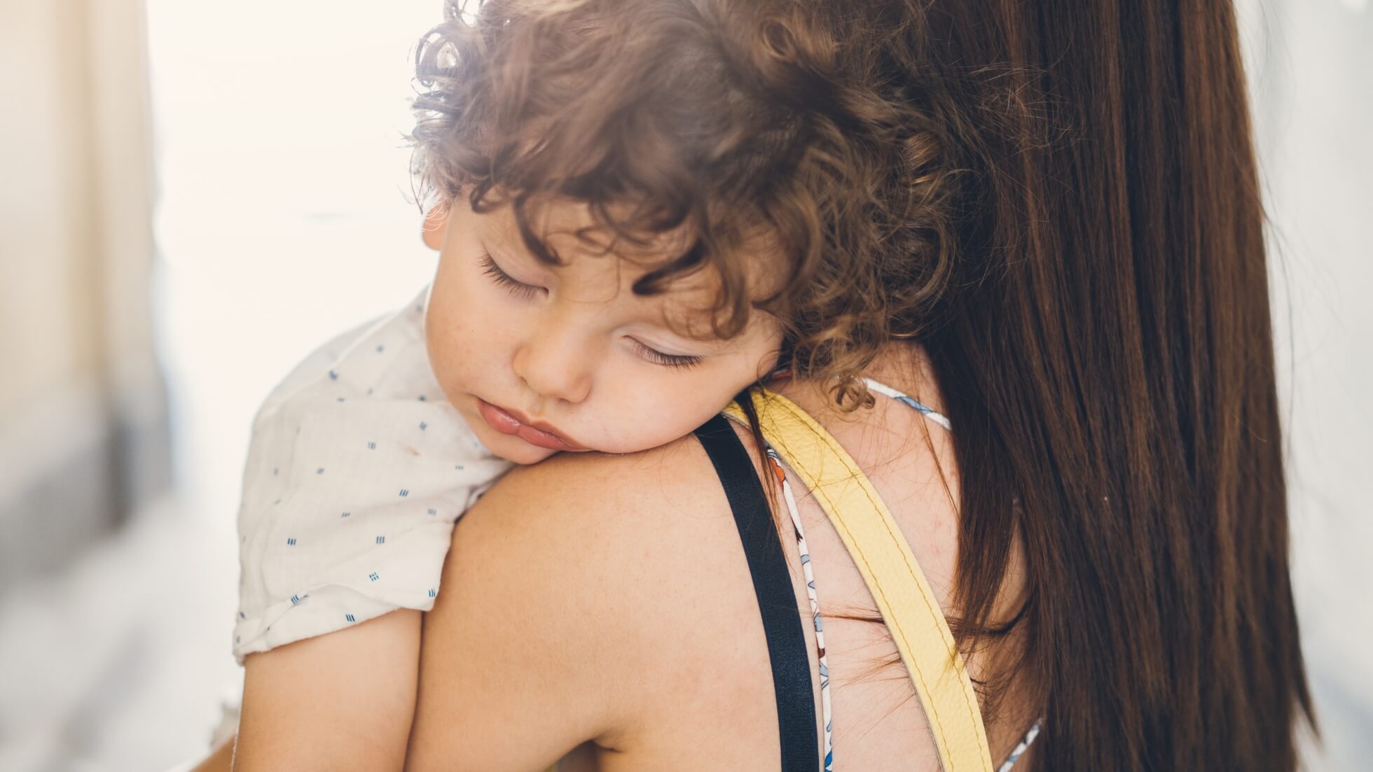 toddler sleeping on mom