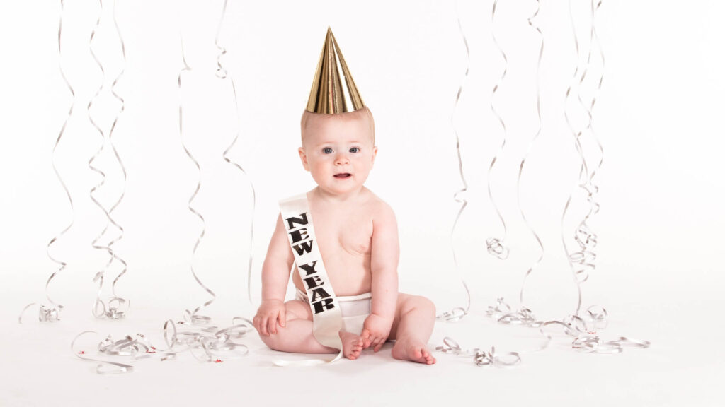 baby with birthday party hat