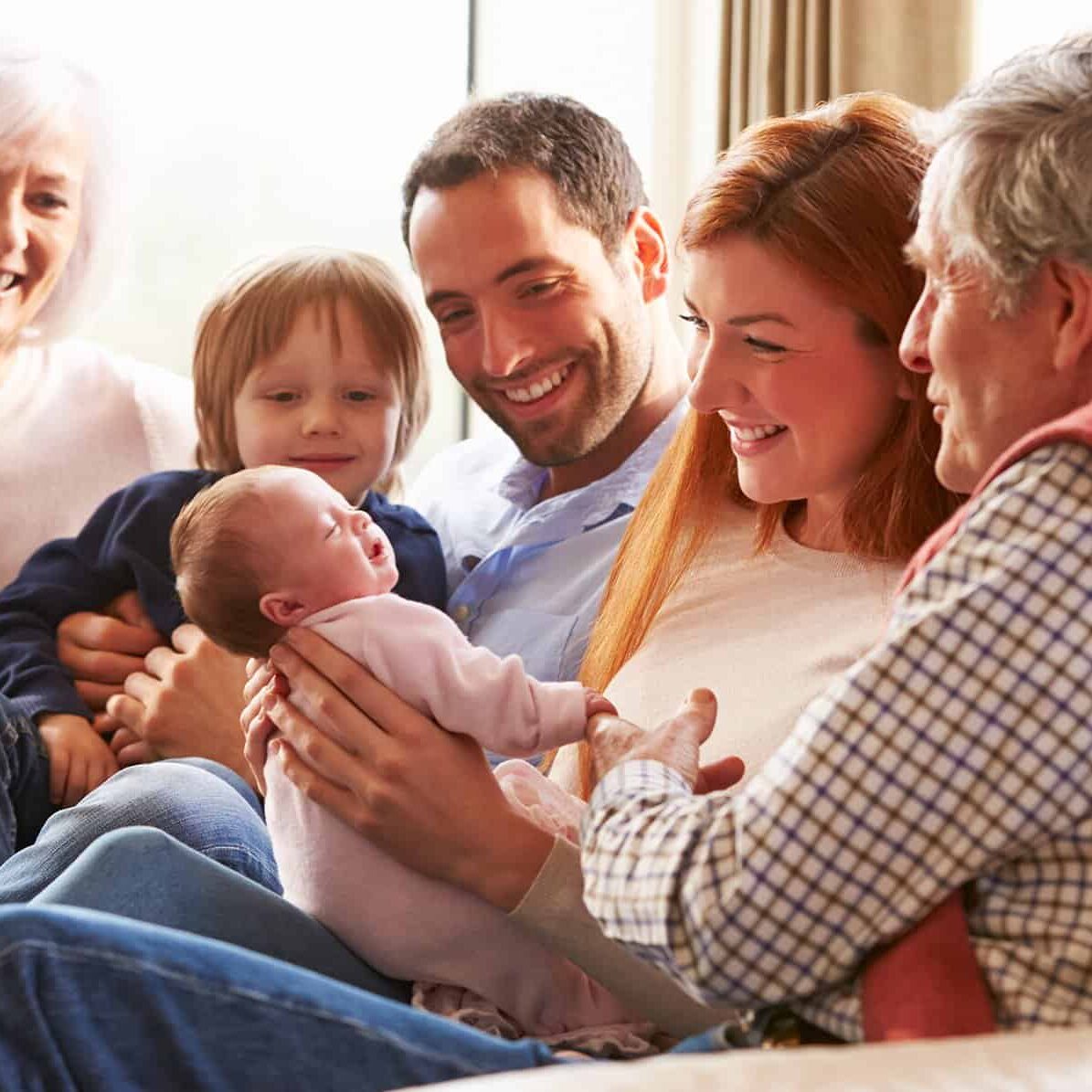 Family and grandparents with new baby