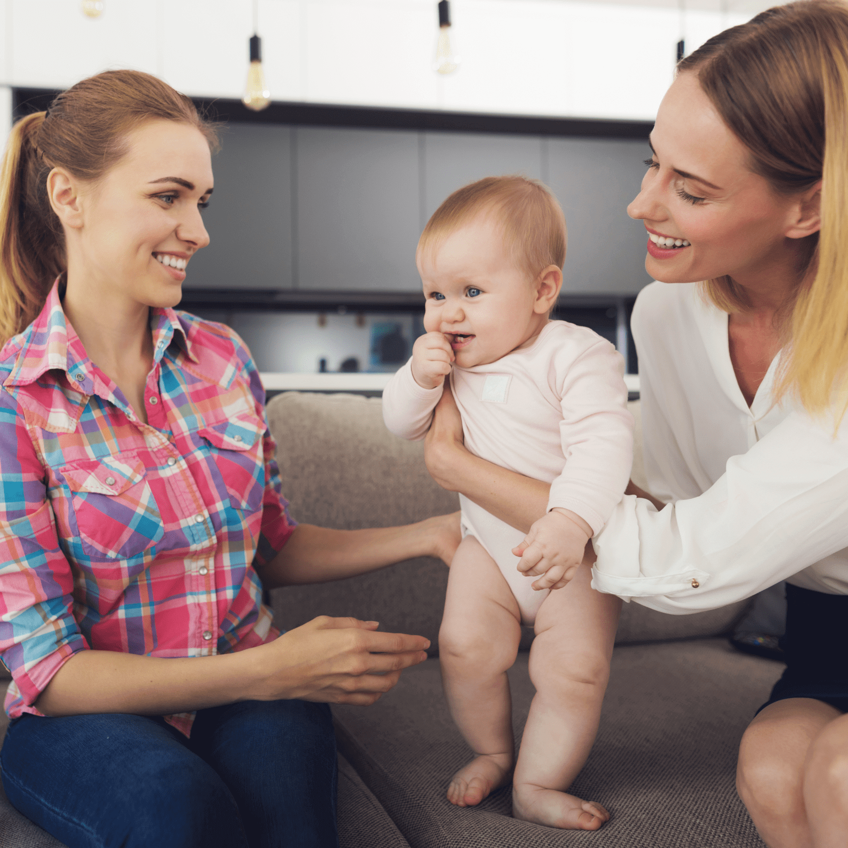 mom nanny and baby sitting on couch